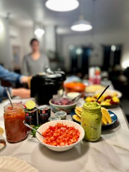 Taco buffet with salsa, guacamole, and beans