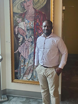 Man standing in front of large painting.