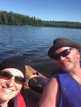 Man and woman in kayak on lake