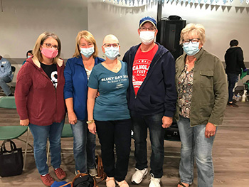 A group of five people wearing medical masks