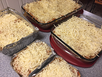 Lasagnas sit on the counter waiting to be cooked. 