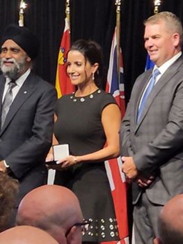 Mary receiving her award, flanked by Minister Harjit Sajjan and PEI Public Safety Minister Bloyce Thompson. 