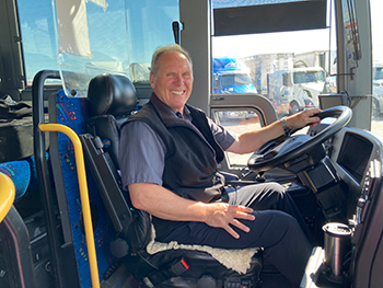 Bus driver smiles at camera