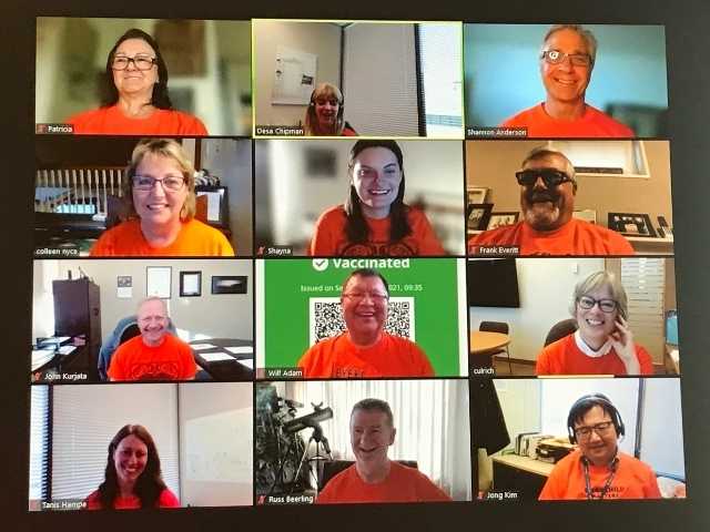 group of people wearing orange shirts on zoom meeting call 