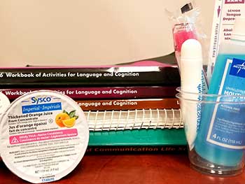 Thickened orange juice and language books on a desk