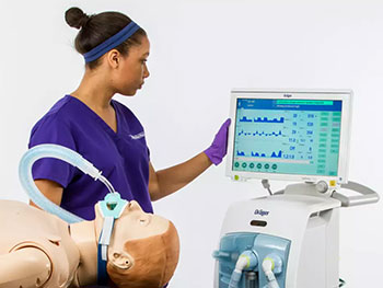 Simulation specialist works with technical health care equipment