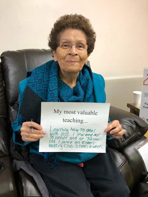 Person holding sign with their most valuable teaching.