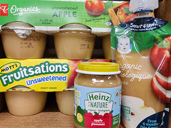 pureed baby food and apple sauce on a store shelf.