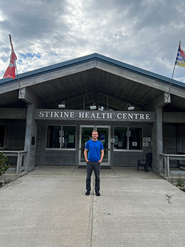 Man stands outside of a health clinic