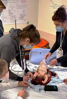 students practice on a simulation baby 
