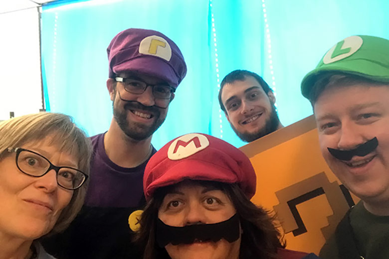 CEO Cathy Ulrich in a selfie with four staff members dressed as characters from Mario Kart.