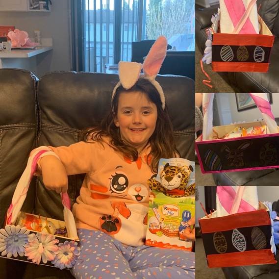 A young girl shows off her homemade Easter basket.