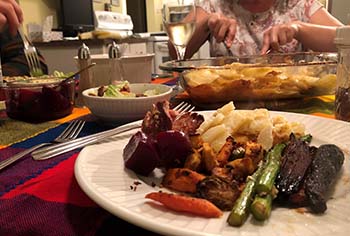 a plate of thanksgiving dinner with several types of food including carrot, asparagus, mash potato, and meat