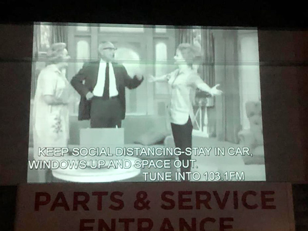 The I Love Lucy Show is projected on an outdoor wall. 