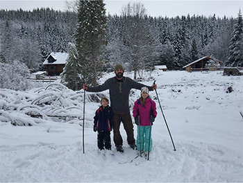 Man and his kids skiing