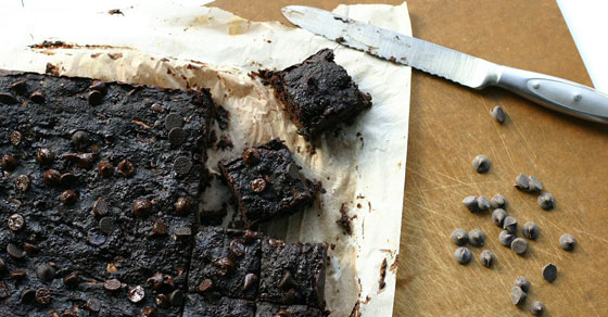Brownies cut into pieces with knife.