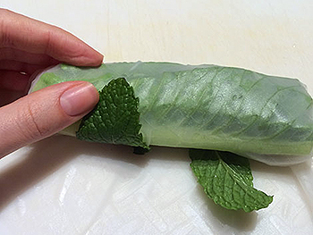 Wrapping spring rolls tightly by hand