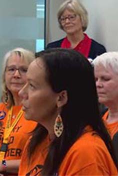 three women wearing orange shirts 