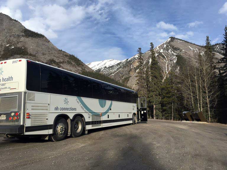 NH Connections bus on a mountain pass.