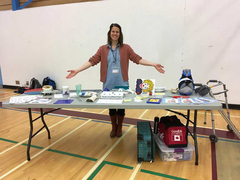 Woman standing at a display table.