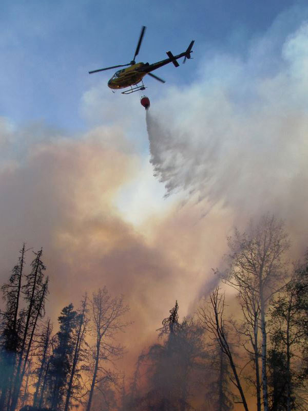 A helicopter delivering water for aerial firefighting near Chetwynd in 2017.