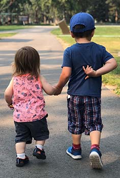 two small boys walking down the street