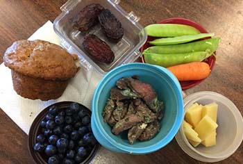 six different snack foods in lunch containers