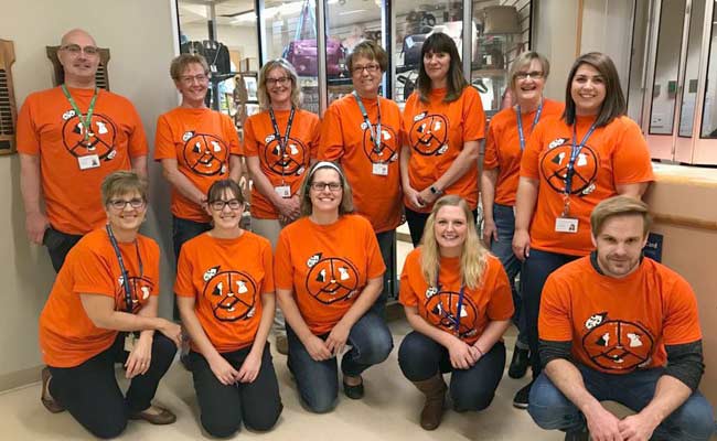 12 members of the G.R. Baker staff are wearing orange shirts in support of Orange Shirt Day.