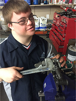 Young man holding a wrench