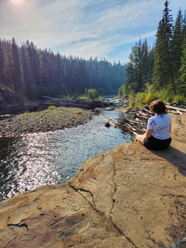 Woman sitting over looking the river