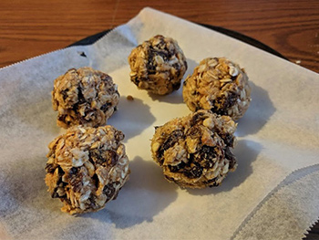 5 energy balls on parchment paper.