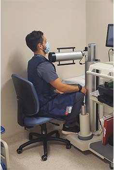 Man sits at scan machine in hospital