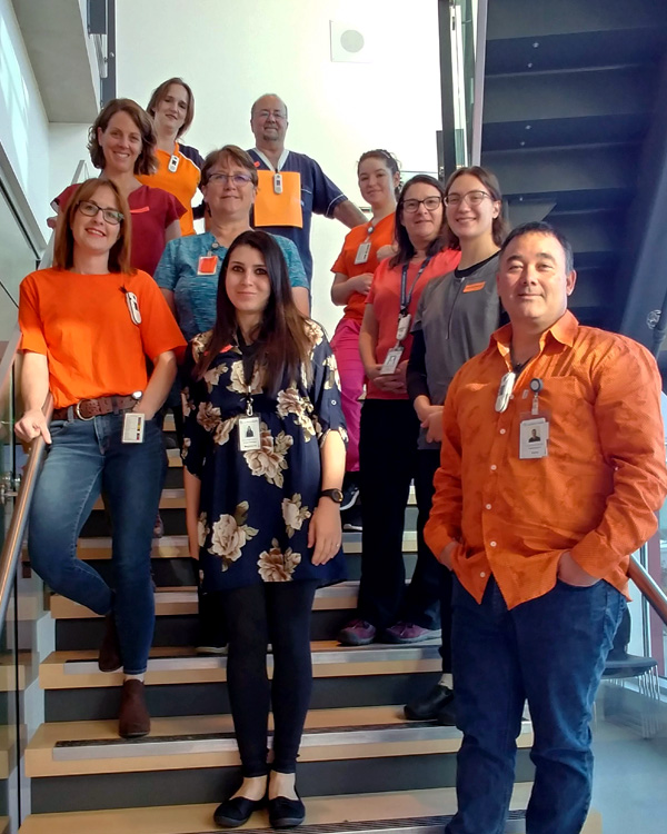 Haida Gwaii Hospital staff standing on stairs for Orange Shirt Day