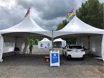 White SUV parked under white tent