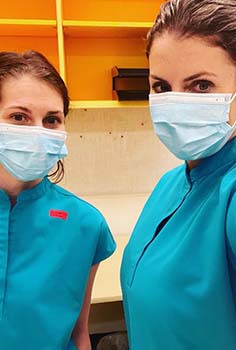 Two lab technicians in masks. 