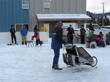Families skating on outdoor ice rink.