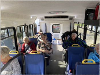 Seniors sit on accessible bus
