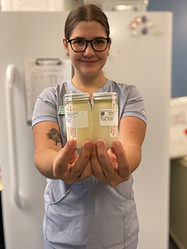 Nurse holds bottles of human milk