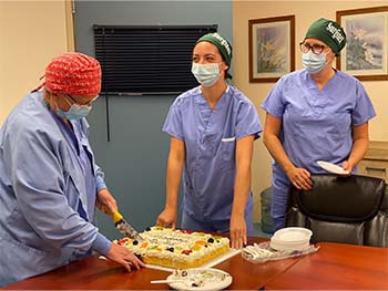 Members from the OR Department, Surgical Services Program, and the Information Management / Information Technology (IM/IT) team at at St. John hospital in Vanderhoof celebrate with cake