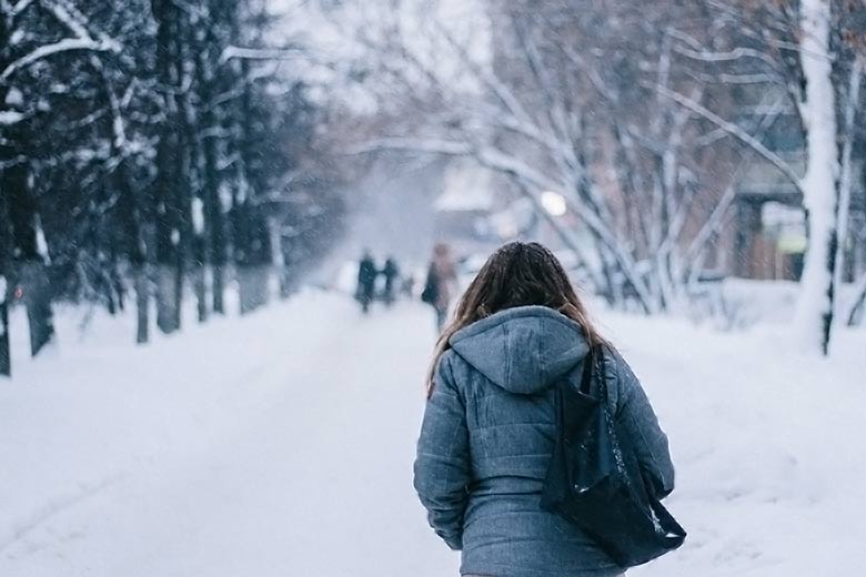 Teen walking to school in snow