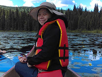 Woman in canoe wearing a red lifejacket