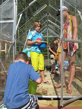 Youth working in a greenhouse