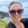Woman with her dark hair pulled back wearing sunglasses