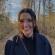 Emily smiling in front of fall colours in the background