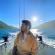 man on boat with mountains