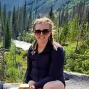 Woman with braids and sunglasses outside in the mountains.
