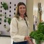 Woman with long hair holds bowl of vegetables