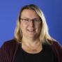 Woman with shoulder length blonde hair and glasses 