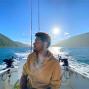 man on boat with mountains