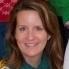 woman with brown hair smiles into the camera